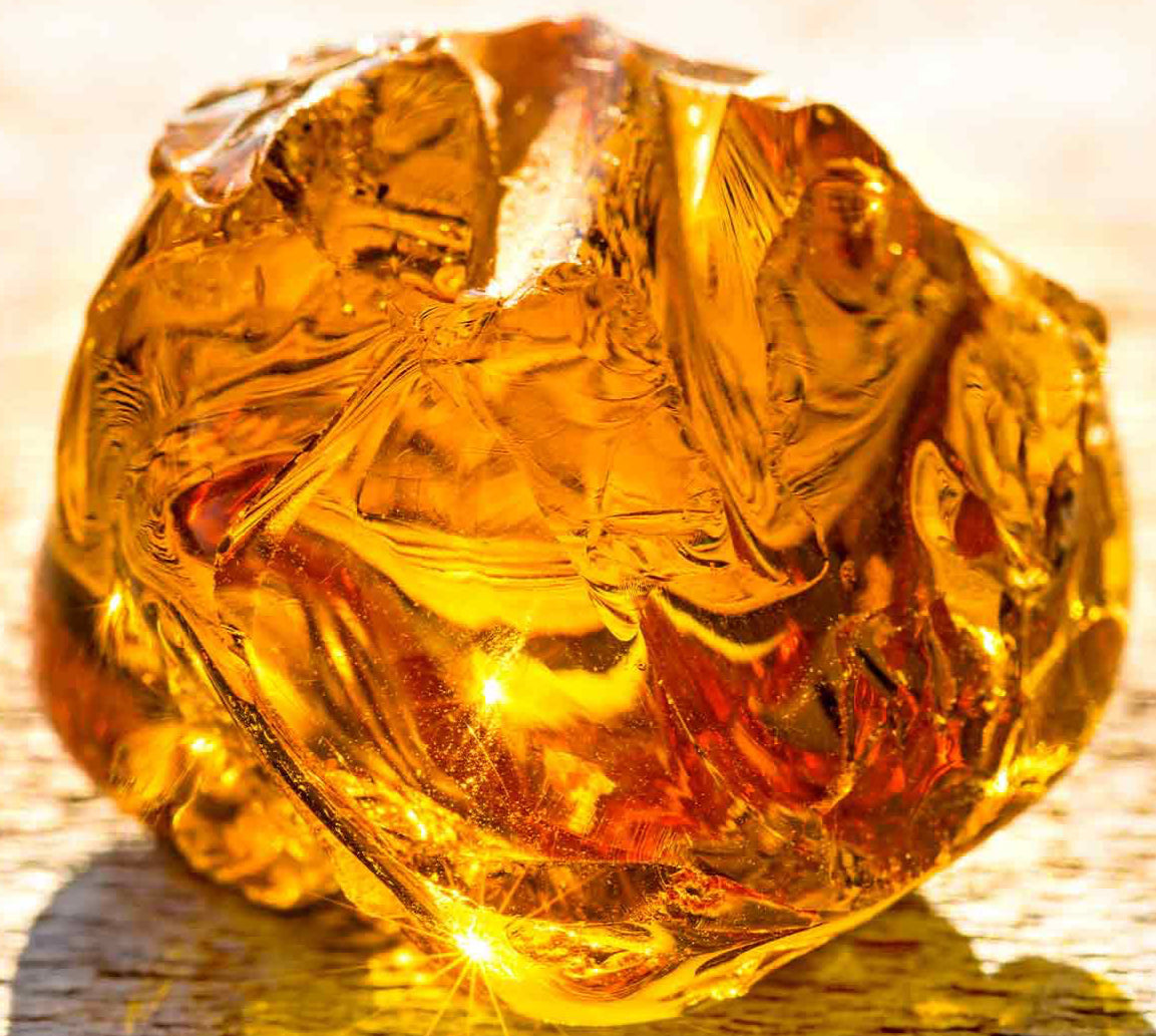 Transparent amber stone on a wooden surface